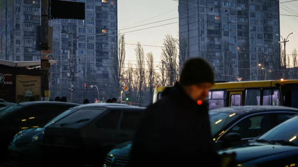A man smokes a cigarette as he walks through a residential area on a frosty winter day, soon after an air alert ended following a Russian missile and drone attack, during a power blackout after critical civil infrastructure was hit recently, amid Russia's attack on Ukraine, in Kyiv, Ukraine January 20, 2026. REUTERS/Alina Smutko   TPX IMAGES OF THE DAY
