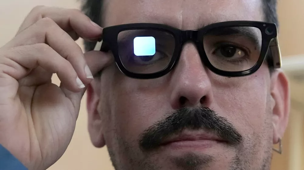 FILE - Michael Mcloughlin, of El Confidencial, gets a demonstration of Gemini on Android XR glasses at a Google I/O event in Mountain View, Calif., Tuesday, May 20, 2025. (AP Photo/Jeff Chiu, File)