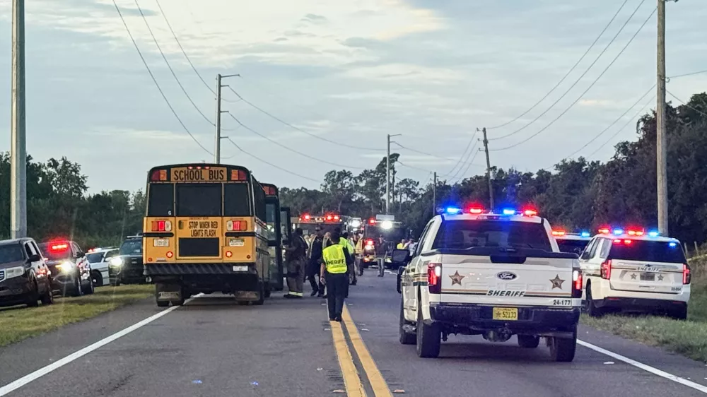 In this photo provided by the Polk County Sheriff's Office, emergency personnel respond to an accident involving a school bus in Winter Haven, Fla., on Monday, Oct. 5, 2026. (Polk County Sheriff's Office via AP)