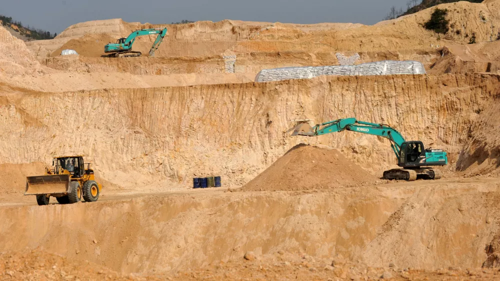 FILE - Workers use machinery to dig at a rare earth mine in Ganxian county in central China's Jiangxi province on Dec. 30, 2010. (Chinatopix via AP, File)