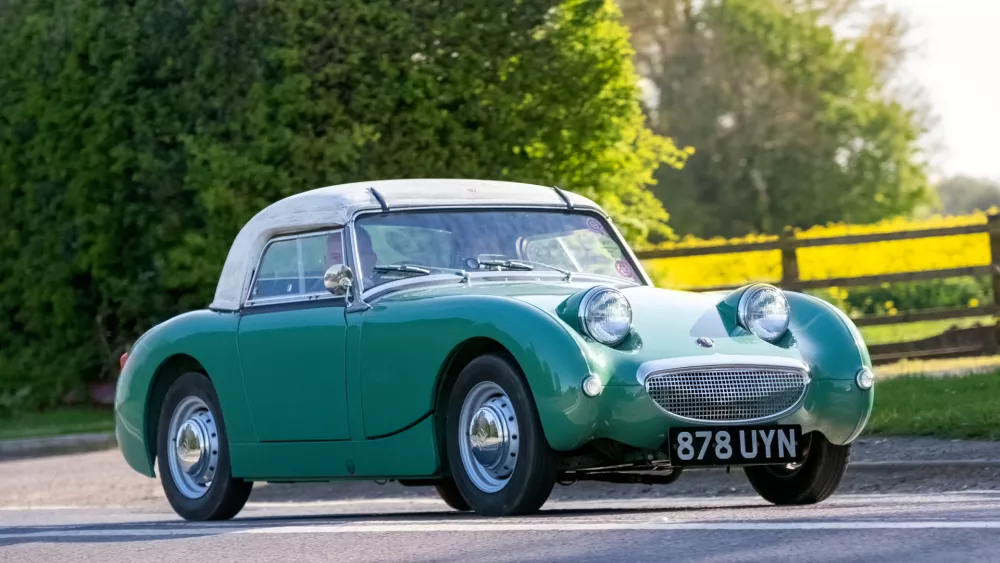 Bicester,UK, Apr 21st 2024, Proud owner driving a classic 1960 Austin Healey "frog eye" Sprite car on the 2024 annual Drive It Day when enthusiasts drive their classic and vintage cars