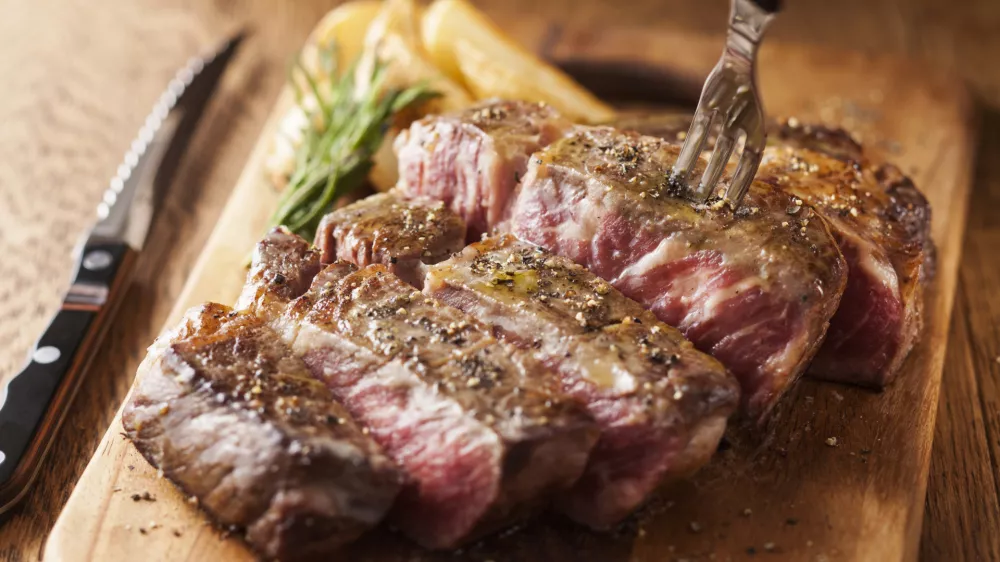 A domestic Wagyu steak simply grilled with salt and pepper, cooked to a perfect medium-rare with a savory sear and a juicy red center.