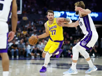 Oct 5, 2026; Sacramento, California, USA; Los Angeles Lakers guard Luka Doncic (77) drives with the ball against Sacramento Kings forward Domantas Sabonis (11) during the first quarter at Golden 1 Center. Mandatory Credit: Sergio Estrada-Imagn Images