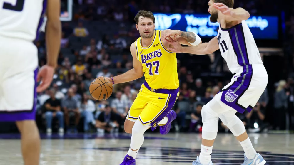 Oct 5, 2026; Sacramento, California, USA; Los Angeles Lakers guard Luka Doncic (77) drives with the ball against Sacramento Kings forward Domantas Sabonis (11) during the first quarter at Golden 1 Center. Mandatory Credit: Sergio Estrada-Imagn Images