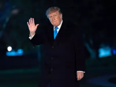 President Donald Trump waves to reporters as he walks on the South Lawn upon his arrival at the White House, Monday, Oct. 5, 2026, in Washington. (AP Photo/Jose Luis Magana)