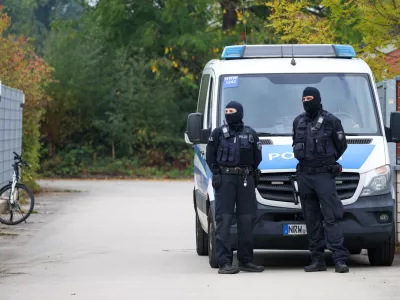 Police officers are stationed at the entrance to the home of former president of the Federal Intelligence Service, or BND, August Hanning, 80, who was arrested on suspicion of espionage, in Nordwalde, Germany, Tuesday, Oct. 6, 2026. (Christoph Reichwein/dpa via AP)