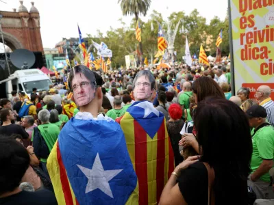 FILE PHOTO: People wear card board masks with the image of exiled Catalan separatist leader Carles Puigdemont during a demonstration on Catalonia's national day of 'La Diada' in Barcelona, Spain, September 11, 2024. REUTERS/Bruna Casas/File Photo