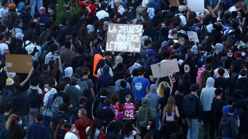 Protesters holds a placard reading "Youth says screw the National Front" at Place de la Nation during a demonstration by high school and university students, supported by teachers' union and school parents, in Paris as part of a nationwide day of demonstrations and blockades, voicing anger over overcrowded classrooms, teacher shortages and dilapidated school buildings, which students blame on years of underinvestment, France, October 6, 2026. REUTERS/Yves Herman