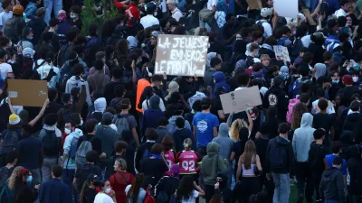 Protesters holds a placard reading "Youth says screw the National Front" at Place de la Nation during a demonstration by high school and university students, supported by teachers' union and school parents, in Paris as part of a nationwide day of demonstrations and blockades, voicing anger over overcrowded classrooms, teacher shortages and dilapidated school buildings, which students blame on years of underinvestment, France, October 6, 2026. REUTERS/Yves Herman