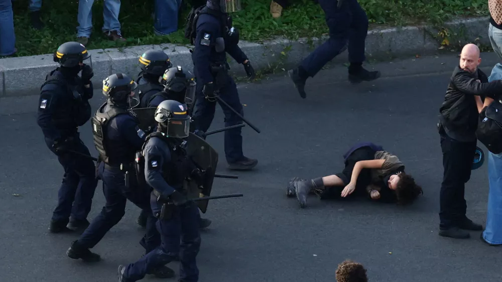 French CRS riot police charge protesters amid clashes at Place de la Nation during a demonstration by high school and university students, supported by teachers' union and school parents, in Paris as part of a nationwide day of demonstrations and blockades, voicing anger over overcrowded classrooms, teacher shortages and dilapidated school buildings, which students blame on years of underinvestment, France, October 6, 2026. REUTERS/Yves Herman   TPX IMAGES OF THE DAY