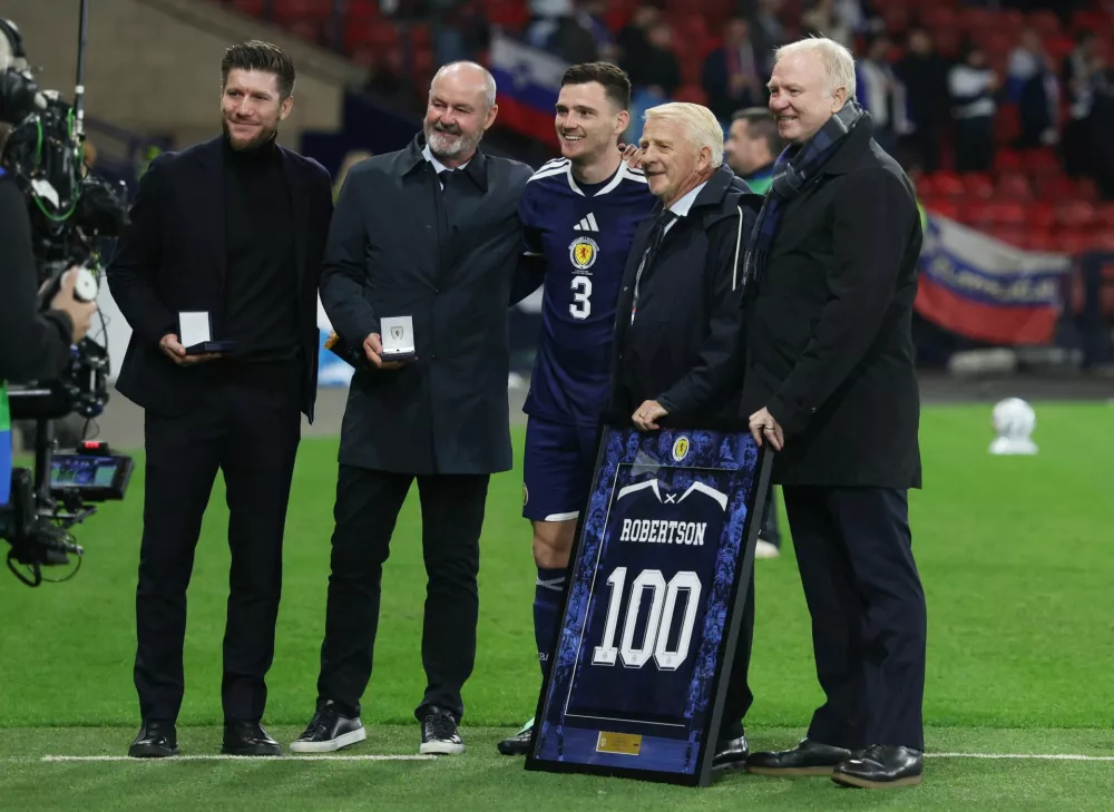 Soccer Football - Nations League - Group B1 - Scotland v Slovenia - Hampden Park, Glasgow, Scotland, Britain - October 6, 2026 Scotland's Andy Robertson is presented a shirt for his hundredth cap by Scotland manager Sebastien Pocognoli and former managers Steve Clarke, Gordon Strachan and Alex McLeish before the match REUTERS/Russell Cheyne