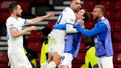 Slovenia's Aljosa Matko, center left, celebrates scoring with teammates during the Nations League soccer match between Scotland and Slovenia in Glasgow, Scotland, Tuesday Oct. 6, 2026. (Andrew Milligan/PA via AP)