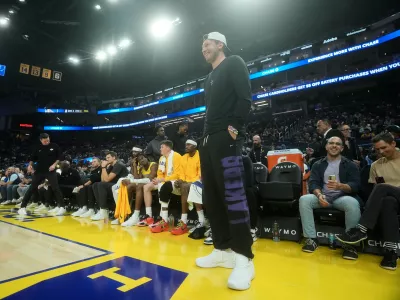 Los Angeles Lakers guard Luka Doncic stands in front of the bench during the first half of an NBA preseason basketball game against the Golden State Warriors, Tuesday, Oct. 6, 2026, in San Francisco. (AP Photo/Jeff Chiu)