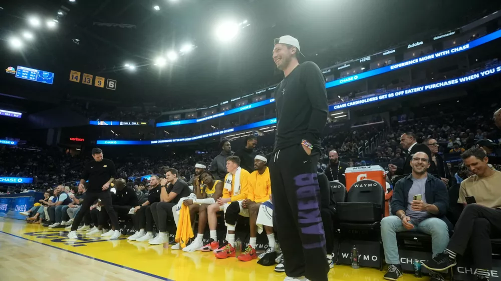 Los Angeles Lakers guard Luka Doncic stands in front of the bench during the first half of an NBA preseason basketball game against the Golden State Warriors, Tuesday, Oct. 6, 2026, in San Francisco. (AP Photo/Jeff Chiu)