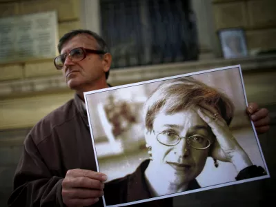 A protester holds a picture of murdered Russian journalist Anna Politkovskaya during a demonstration for freedom of speech and the press in Sofia October 7, 2008. Politkovskaya, a critic of the former Russian President Putin, was shot dead in her Moscow apartment building two years ago. REUTERS/Stoyan Nenov  (BULGARIA)