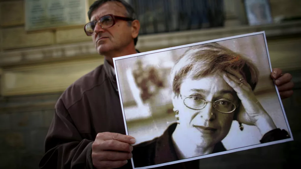 A protester holds a picture of murdered Russian journalist Anna Politkovskaya during a demonstration for freedom of speech and the press in Sofia October 7, 2008. Politkovskaya, a critic of the former Russian President Putin, was shot dead in her Moscow apartment building two years ago. REUTERS/Stoyan Nenov  (BULGARIA)
