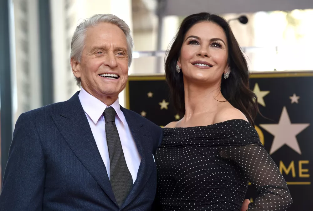 FILE - Actor Michael Douglas, left, and his wife Catherine Zeta-Jones appear at a ceremony honoring him with a star on the Hollywood Walk of Fame in Los Angeles on Nov. 6, 2018. (Photo by Chris Pizzello/Invision/AP, File)