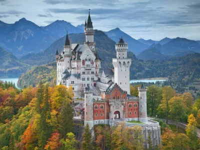 Hohenschwangau, Germany - October 7, 2014: view of Neuschwanstein Castle on october 7th near Hohenschwangau, Germany during autumn afternoon surrounded by fall colours.