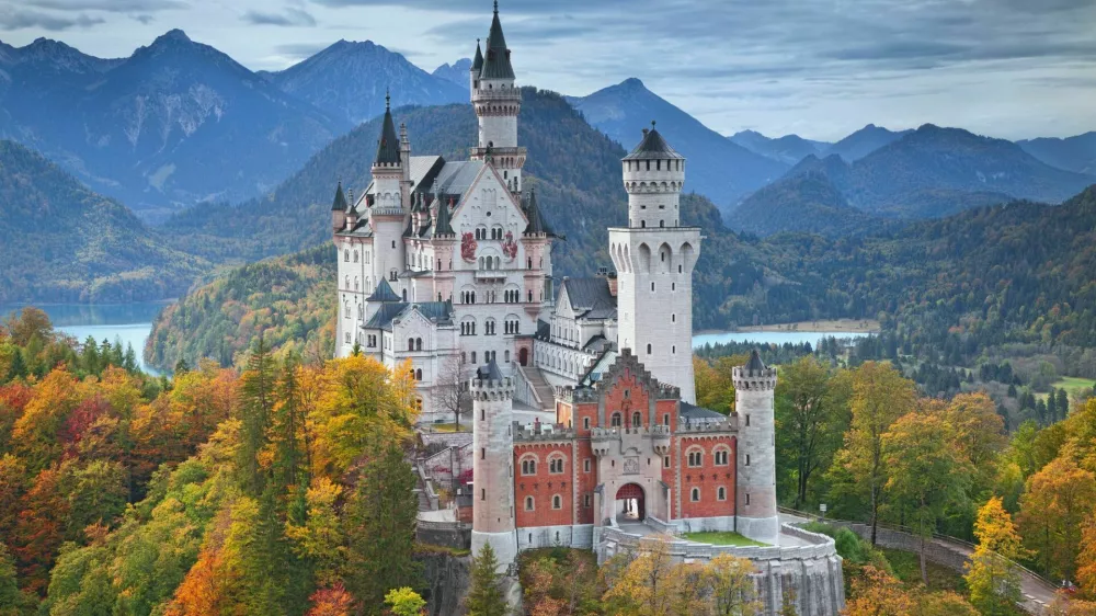 Hohenschwangau, Germany - October 7, 2014: view of Neuschwanstein Castle on october 7th near Hohenschwangau, Germany during autumn afternoon surrounded by fall colours.