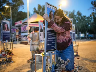 Raz Zarfati, sister of Ron Zarfati who was killed in the Oct. 7, 2023, Hamas-led attack on Israel, attend a memorial marking the third anniversary of the attack at the Nova music festival site near Kibbutz Reim, southern Israel, Wednesday, Oct. 7, 2026. (AP Photo/Ohad Zwigenberg)