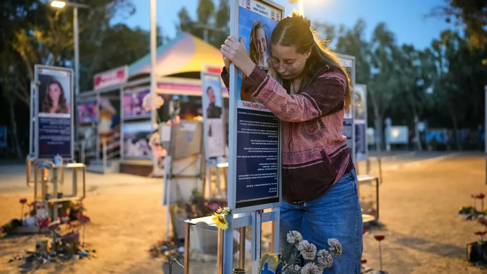 Raz Zarfati, sister of Ron Zarfati who was killed in the Oct. 7, 2023, Hamas-led attack on Israel, attend a memorial marking the third anniversary of the attack at the Nova music festival site near Kibbutz Reim, southern Israel, Wednesday, Oct. 7, 2026. (AP Photo/Ohad Zwigenberg)