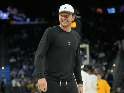 Los Angeles Lakers guard Luka Doncic smiles while walking on the floor during the second half of an NBA preseason basketball game against the Golden State Warriors, Tuesday, Oct. 6, 2026, in San Francisco. (AP Photo/Jeff Chiu)