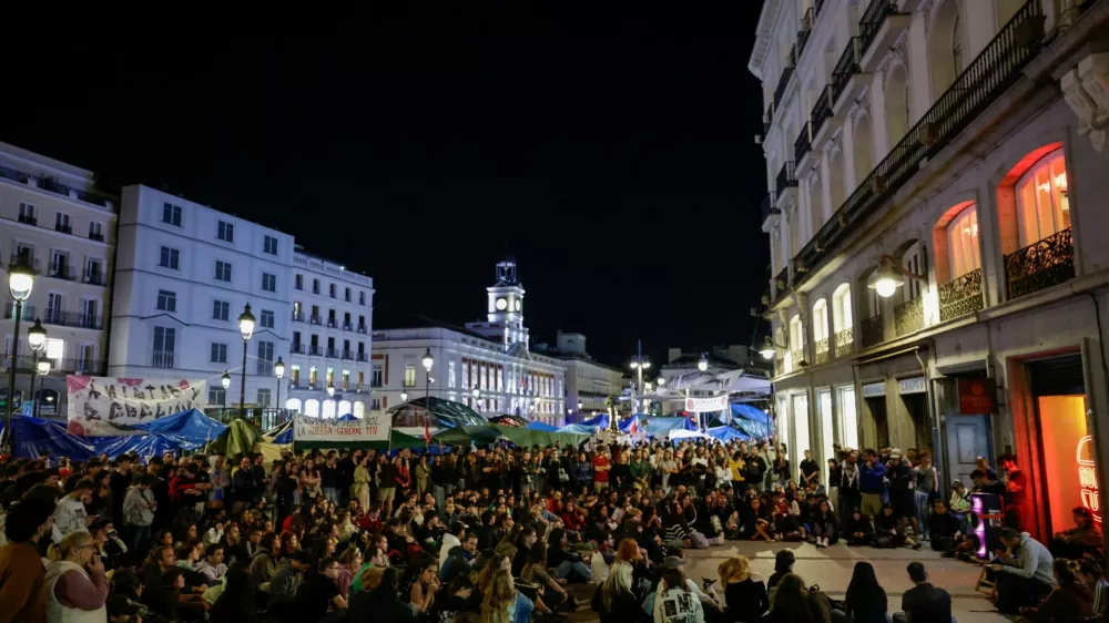People gather at the protest camp at Puerta del Sol square following the death of Maricarmen Abascal, the 87-year-old woman whose eviction sparked housing protests in Spain, in Madrid, Spain, October 7, 2026. REUTERS/Violeta Santos Moura