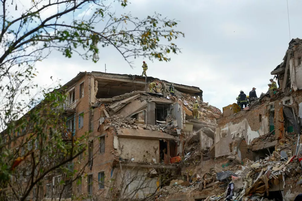 Rescuers work at the site of an apartment building which was hit by a Russian missile strike in the town of Pryluky, amid Russia's attack on Ukraine, in the Chernihiv region, Ukraine, October 7, 2026. REUTERS/Valentyn Ogirenko