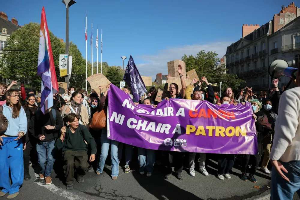 Protesters hold a Union Pirate banner that reads "Neither cannon fodder, nor boss fodder", as French high school and university students attend a demonstration in Nantes as part of a nationwide day of protests and blockades to demand better school conditions in France, October 8, 2026. REUTERS/Stephane Mahe