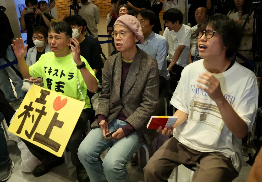 Fans of Japanese writer Haruki Murakami react as they watch the announcement of the 2026 Nobel Prize in Literature, awarded to Canadian poet Anne Carson, at a live-viewing event at a bookstore in Tokyo, Japan, October 8, 2026. REUTERS/Kim Kyung-Hoon