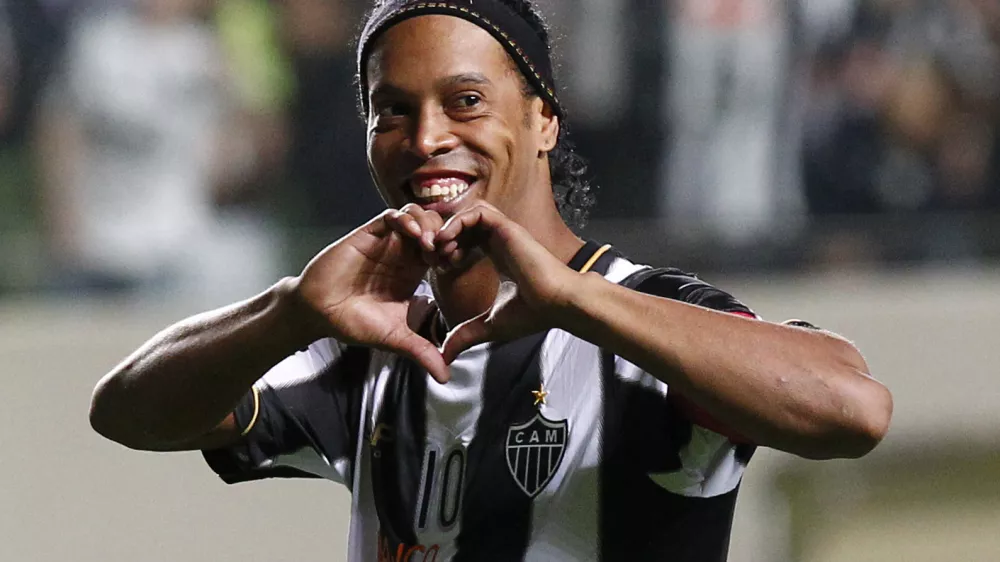 FILE - In this July 11, 2013 file photo, Brazil's Atletico Mineiro's Ronaldinho celebrates his team's victory over Argentina's Newell's Old Boys at the end of a Copa Libertadores semifinal soccer match in Belo Horizonte, Brazil. The brother and agent of 2005 Ballon d'Or winner Ronaldinho says the former Brazil and Barcelona playmaker has retired from football. (AP Photo/Bruno Magalhaes, File)