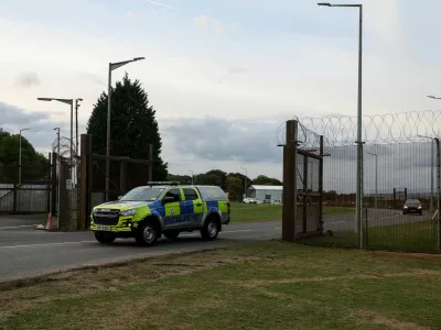 A police car leaves RAF Molesworth, after two Latvian nationals were arrested on suspicion of entering a prohibited place for a purpose prejudicial to the UK, police said in a statement, in Cambridgeshire, Britain, October 8, 2026. REUTERS/Chris Radburn   TPX IMAGES OF THE DAY