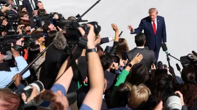 President Donald Trump speaks to reporters before boarding Marine One at the White House on Wednesday, Oct. 7, 2026, in Washington. (AP Photo/Tom Brenner)