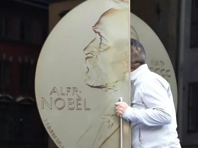 A visitor enters the Nobel Prize Museum through a door with a picture of a Nobel Prize medal on it, in a building which is also home to the Swedish Academy, in Stockholm, Sweden, October 8, 2026. REUTERS/Tom Little    TPX IMAGES OF THE DAY