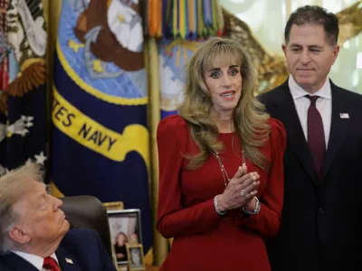 Michael Dell looks on as Susan Dell speaks on the day US President Donald Trump makes an announcement regarding personal investment accounts for children in the Oval Office at the White House in Washington, D.C., US, October 7, 2026. REUTERS/Jonathan Ernst