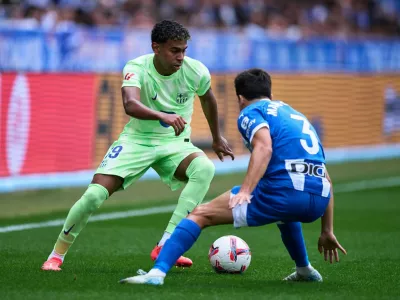 Lamine Yamal of FC Barcelona duels for the ball with Manu Sanchez of Deportivo Alaves during the LaLiga EA Sports match between Deportivo Alaves v FC Barcelona at the Estadio Mendizorrotza on October 6, 2024 in Vitoria, Spain.,Image: 1008220234, License: Rights-managed, Restrictions: Usage restrictions: Advertising and promotion,Commercial electronic,Consumer goods,Direct mail and brochures,Indoor display,Internal business usage,Personal use, Model Release: no 