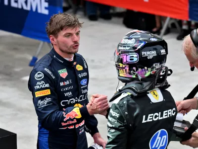 Formula One F1 - Singapore Grand Prix - Marina Bay Street Circuit, Singapore - October 10, 2026 Red Bull's Max Verstappen shakes hands with third placed Ferrari's Charles Leclerc after winning the sprint race REUTERS/Caroline Chia