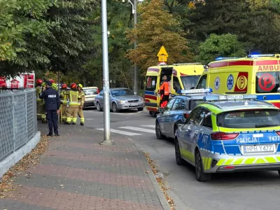 Emergency personnel stand next to vehicles outside a school, following a stabbing attack injuring several, in Ostroleka, Poland, October 7, 2026, in this picture obtained from social media. Moja Ostroleka/via REUTERS THIS IMAGE HAS BEEN SUPPLIED BY A THIRD PARTY. MANDATORY CREDIT.  VERIFICATION: - The location was verified from the fence, road layout, trees and building, which matched satellite and archive imagery. - The date when the videos were filmed was verified by original metadata and a statement from Polish police that seven people were injured in a knife attack at a school in Ostroleka.