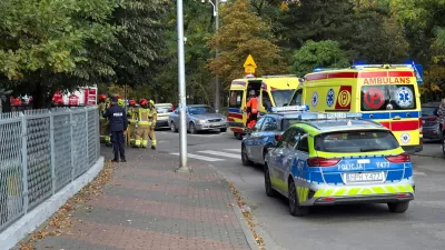 Emergency personnel stand next to vehicles outside a school, following a stabbing attack injuring several, in Ostroleka, Poland, October 7, 2026, in this picture obtained from social media. Moja Ostroleka/via REUTERS THIS IMAGE HAS BEEN SUPPLIED BY A THIRD PARTY. MANDATORY CREDIT.  VERIFICATION: - The location was verified from the fence, road layout, trees and building, which matched satellite and archive imagery. - The date when the videos were filmed was verified by original metadata and a statement from Polish police that seven people were injured in a knife attack at a school in Ostroleka.