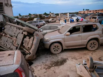 An overturned vehicle rests against a mud-covered one after a tornado struck Marsala, Sicily, Italy, October 9, 2026. REUTERS/Antonio Cascio