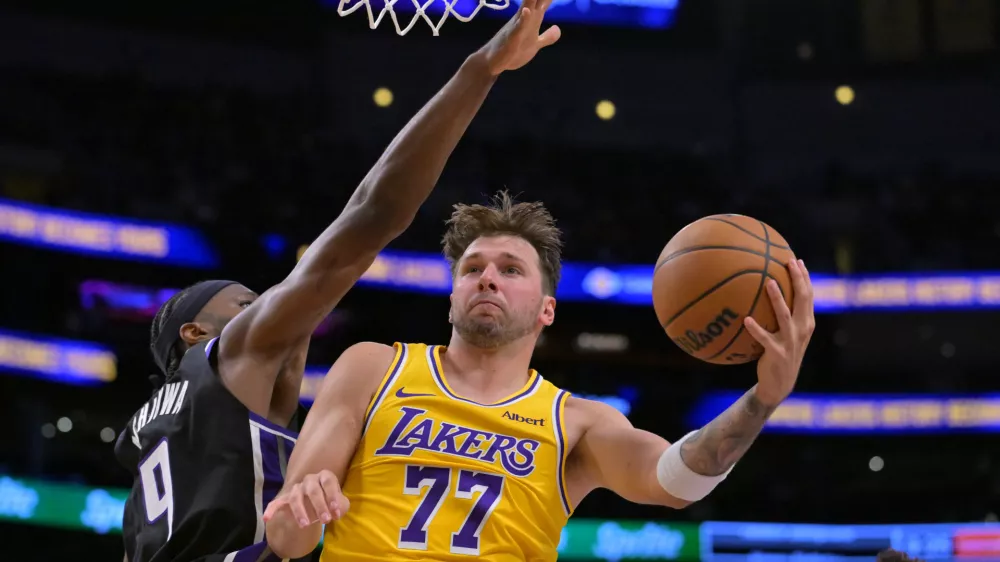 Oct 8, 2026; Los Angeles, California, USA; Los Angeles Lakers guard Luka Doncic (77) is defended by Sacramento Kings forward Precious Achiuwa (9) during the second half at Crypto.com Arena. Mandatory Credit: Jayne Kamin-Oncea-Imagn Images