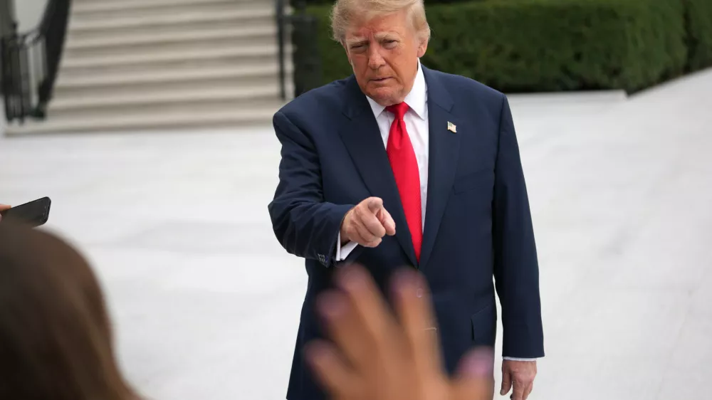 President Donald Trump speaks to members of the media before departing on Marine One from the South Lawn of the White House, Saturday, October 10, 2026, in Washington. (AP Photo/Nathan Howard)