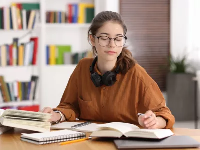Student preparing for exam at table indoors