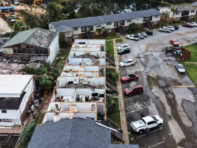 An apartment complex which had its roof ripped off is seen in the aftermath of Hurricane Isaias in Milton, Fla., Saturday, Oct. 10, 2026. (AP Photo/Gerald Herbert)
