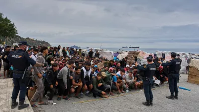Migrants wait for food distribution to begin on El Trampolín Beach in the Spanish enclave of Ceuta, Monday, Sept. 28, 2026. (AP Photo/Bernat Armangue)