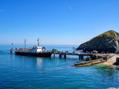 The MS Oldenburg docks at the jetty in Lundy Island bringing visitors and cargo to the shore.