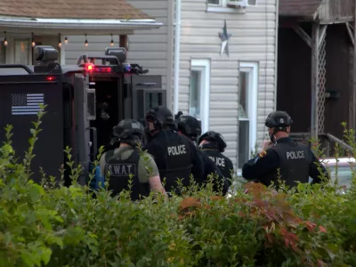 In this image from video provided by WJET, police gather outside the scene of a shooting in Erie, Pa., on Friday evening, Oct. 9, 2026. (Matt Barnum/WJET via AP)