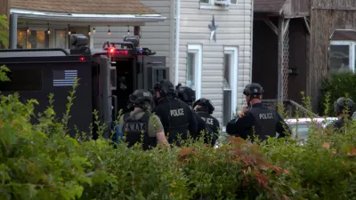 In this image from video provided by WJET, police gather outside the scene of a shooting in Erie, Pa., on Friday evening, Oct. 9, 2026. (Matt Barnum/WJET via AP)