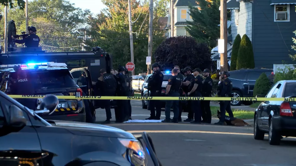 In this image from video provided by WJET, police gather outside the scene of a shooting in Erie, Pa., on Friday evening, Oct. 9, 2026. (Matt Barnum/WJET via AP)