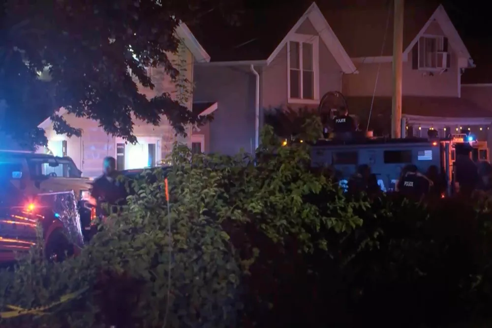In this image from video provided by WJET, police gather outside the scene of a shooting in Erie, Pa., on Friday evening, Oct. 9, 2026. (Matt Barnum/WJET via AP)